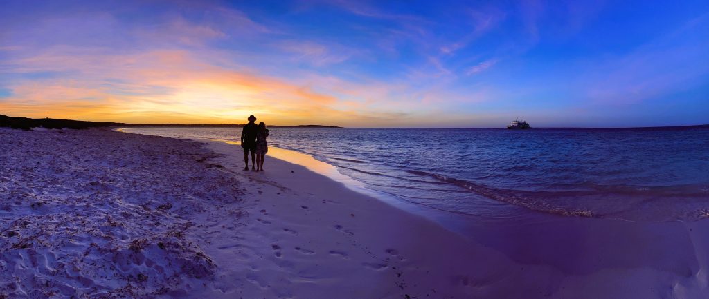 a couple walking on a beach